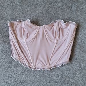 out from under pastel pink and white corset top